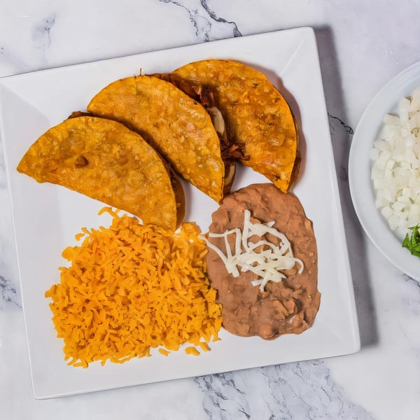 Three golden-fried tacos, refried beans with cheese, and orange rice on a white plate.